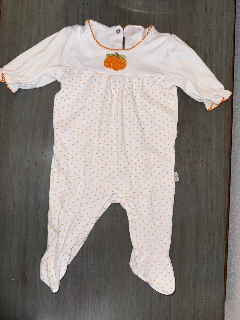 Cozy White Footed One-Piece with Orange Pumpkin Accent
